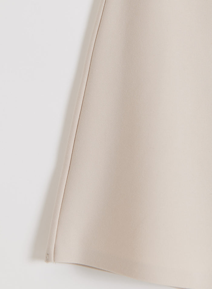 Close-up of the smooth sand modal-blend fabric on the aim'n Luxe Mini Skort.