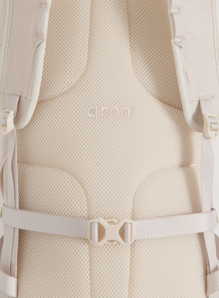 Close-up of the sand Outdoor Daypack showing its breathable mesh back panel, padded shoulder straps and chest buckle