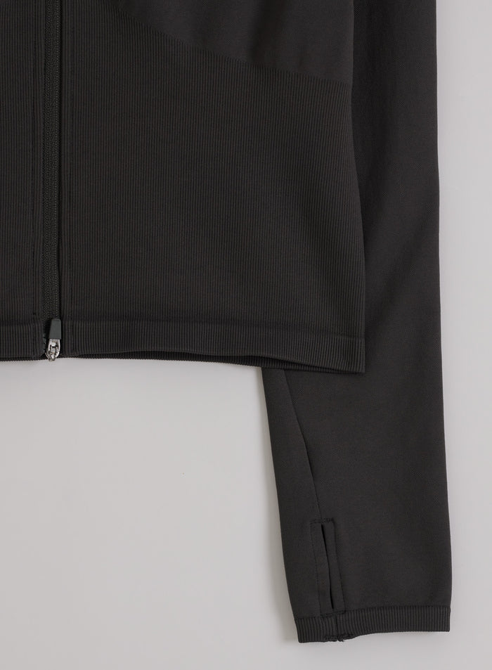 Shadow grey Shape Seamless Zip Jacket by aim'n, showing the ribbed hem, zipper, and sleeve with thumbhole.