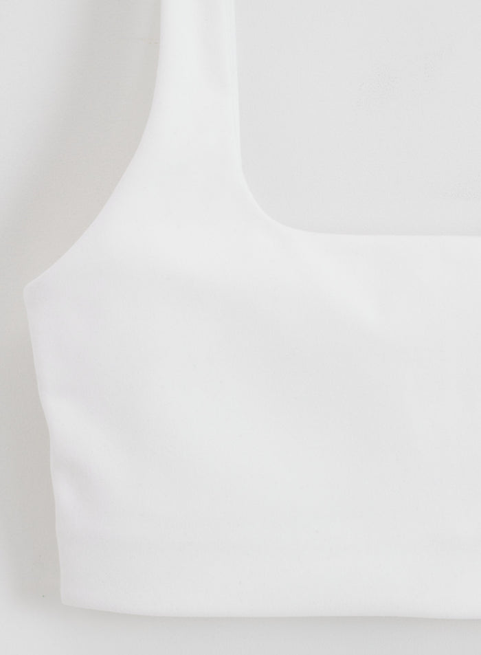 Close-up of the white Sense Bra by aim'n featuring a square neckline and buttery soft fabric.