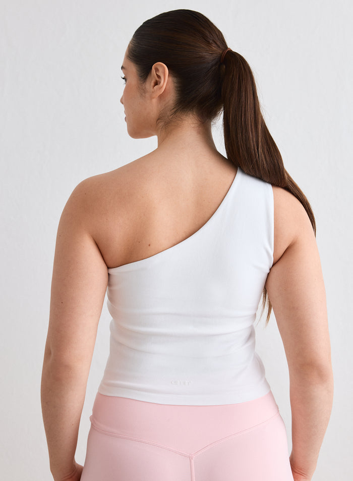 Back view of a model wearing the white Shape Seamless One Shoulder Bralette by aim'n [L-174cm]