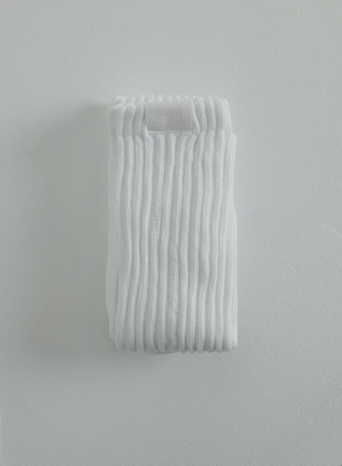 White ribbed Slouch Socks folded to show the discreet aim'n logo badge