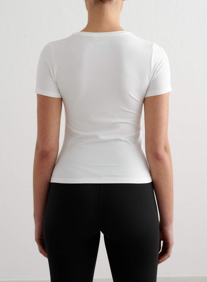 Tight-fitting white short-sleeve top from aim'n with a soft feel, featuring a small logo on the back neckline.